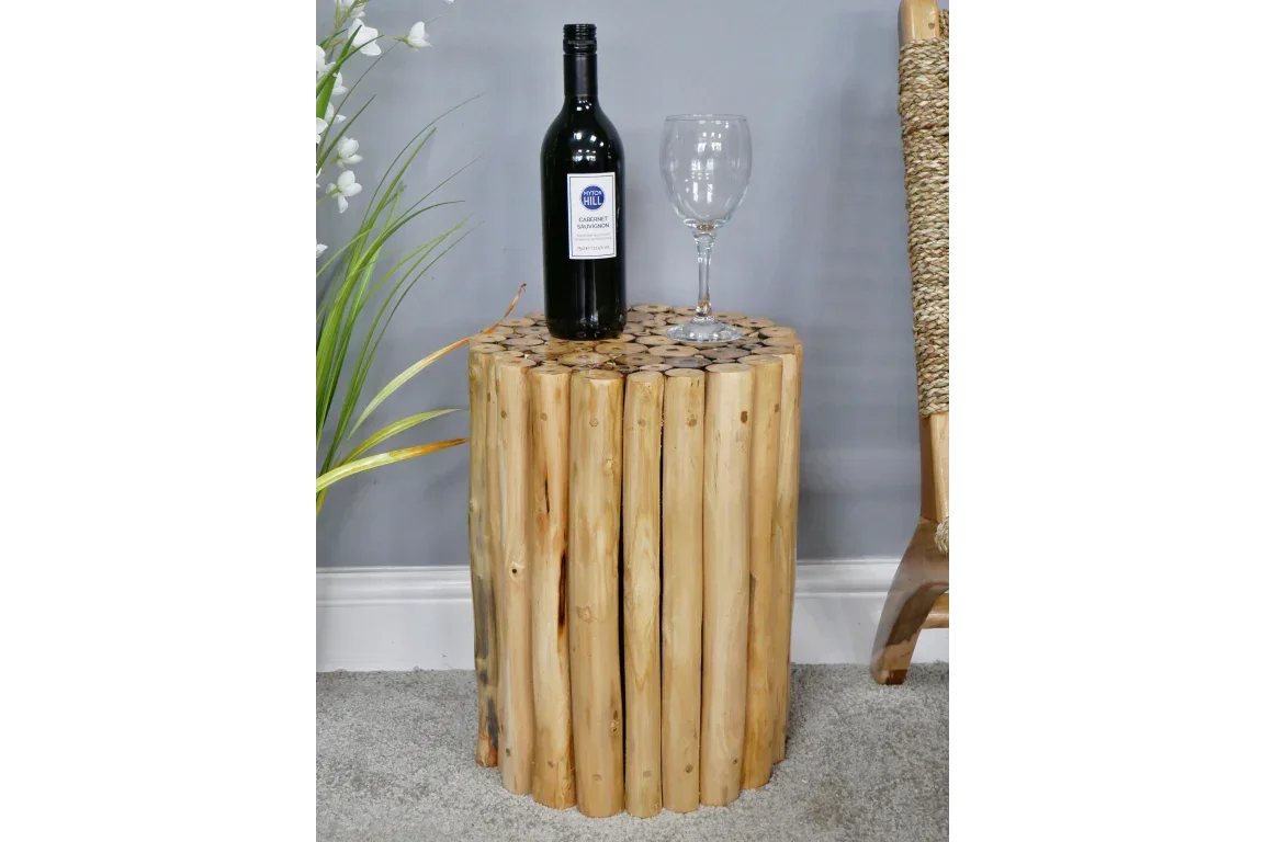 Round wooden side table with natural log design, wine bottle and glass on top