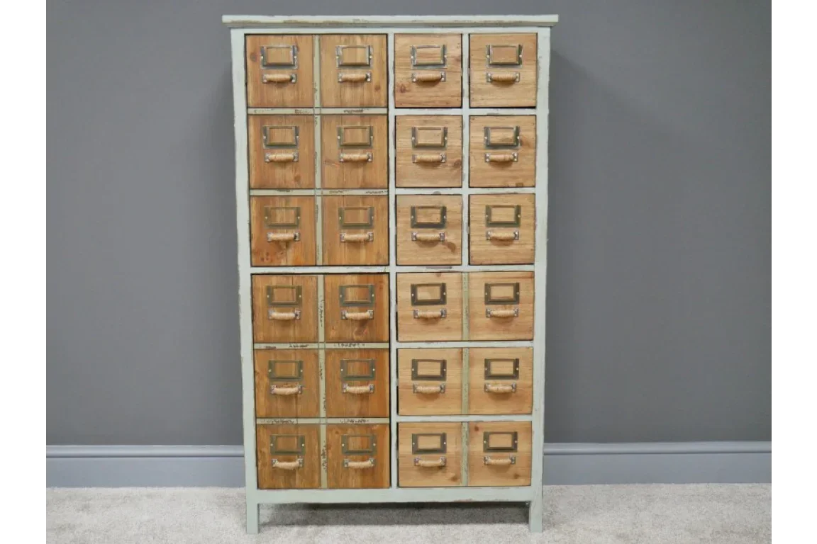 Wooden storage cabinet with 20 drawers and metal handles against a grey wall