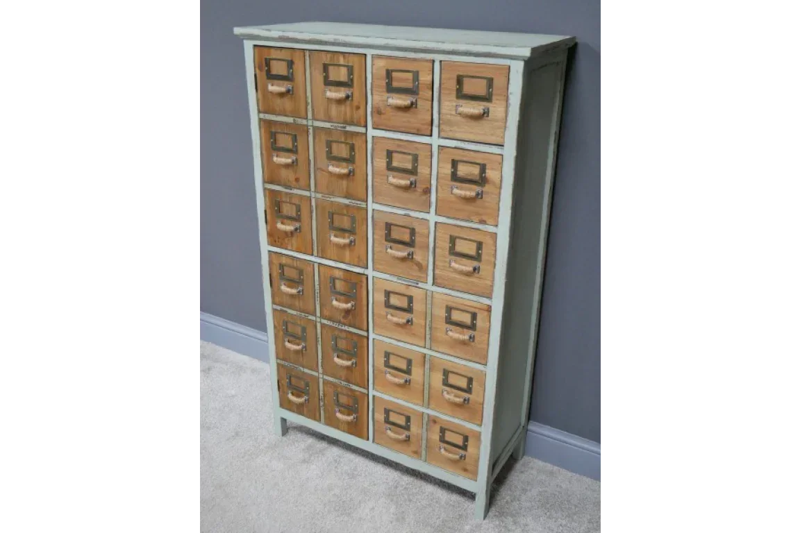 Vintage wooden storage cabinet with 20 small drawers and metal handles against grey wall