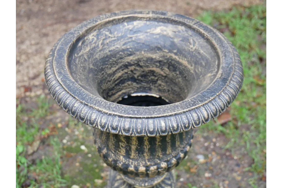 Black stone effect garden planter with decorative rim on outdoor ground