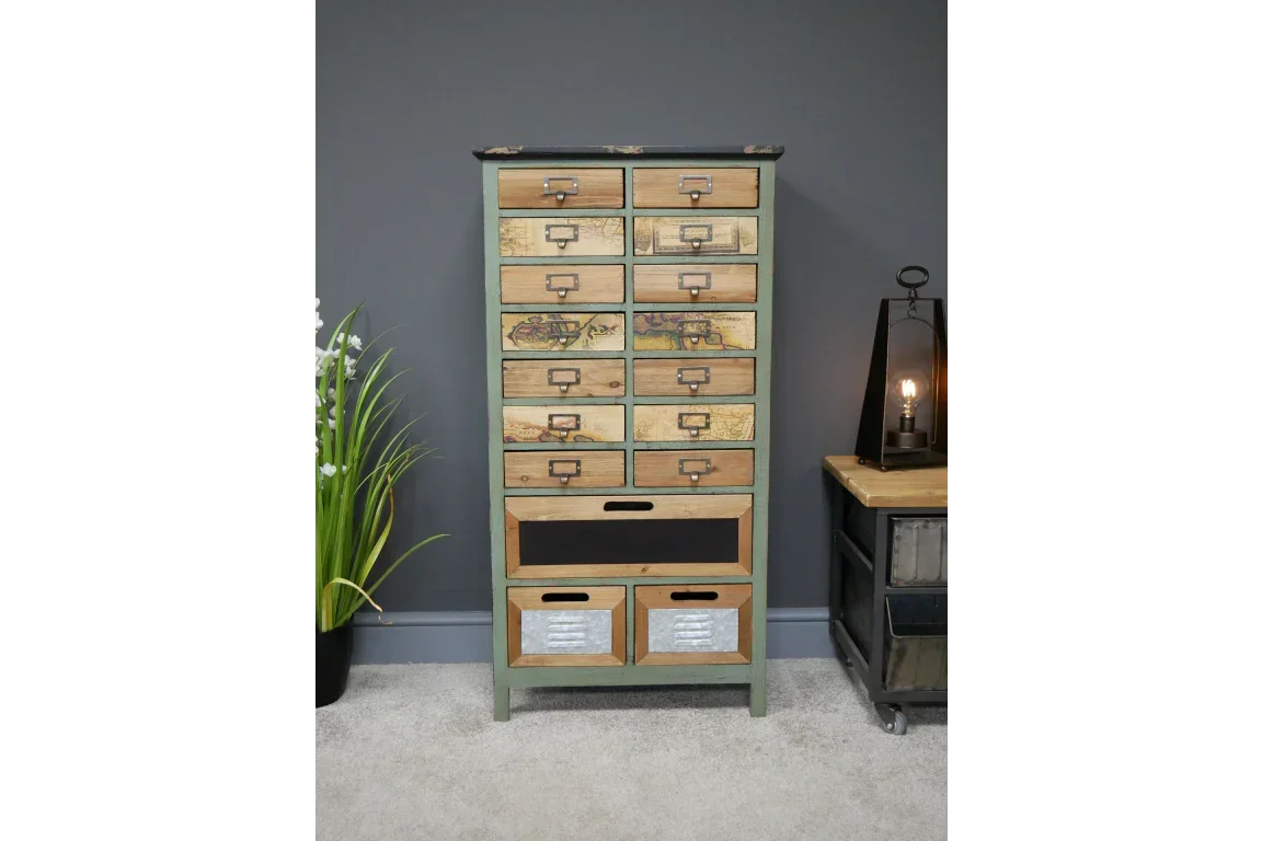 Tall multi drawer chest with map prints and metal accents against grey wall