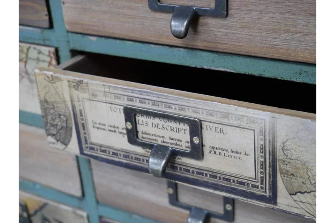 Close-up of wooden storage drawer with map design and metal handle, drawer partially open