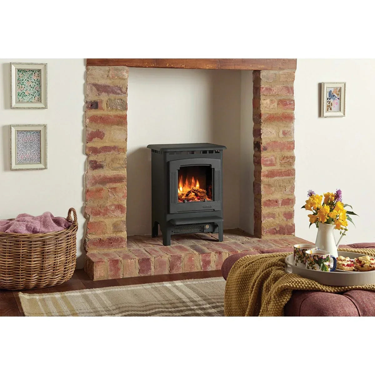 Freestanding black electric stove heater with flame effect in brick fireplace setting