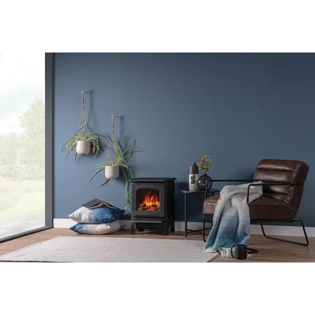 Electric fireplace stove with brown accent chair and blue wall in modern living room