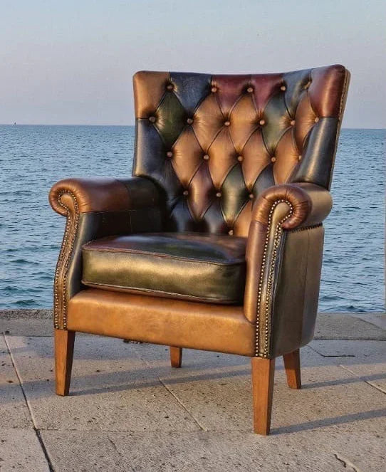 Tufted leather armchair with wooden legs on seaside patio
