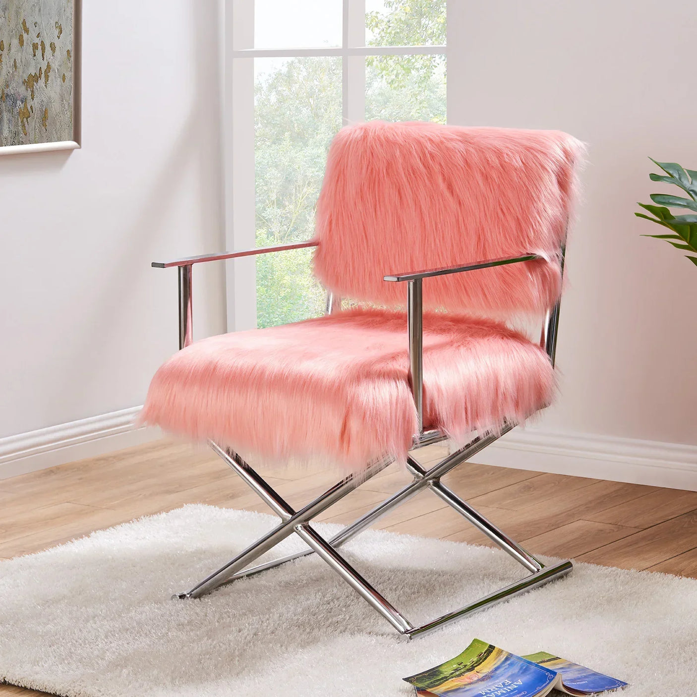 Pink faux fur accent chair with chrome legs and arms on white rug in modern living room