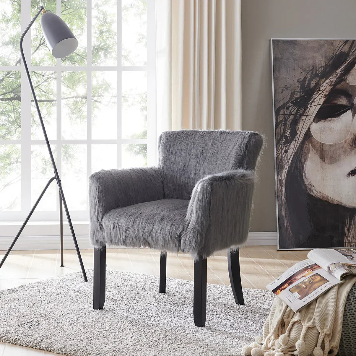 Grey faux fur accent chair with black legs on a rug in modern living room