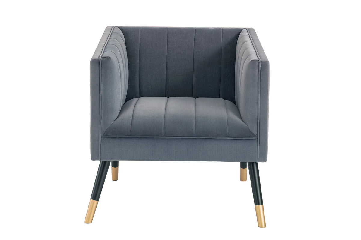 Grey velvet armchair with vertical stitching and gold-tipped black legs, front view