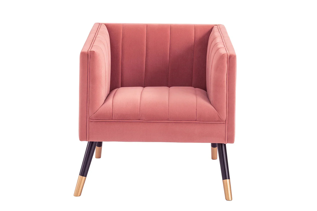 Pink velvet armchair with vertical stitched detailing and black legs with gold tips, front view