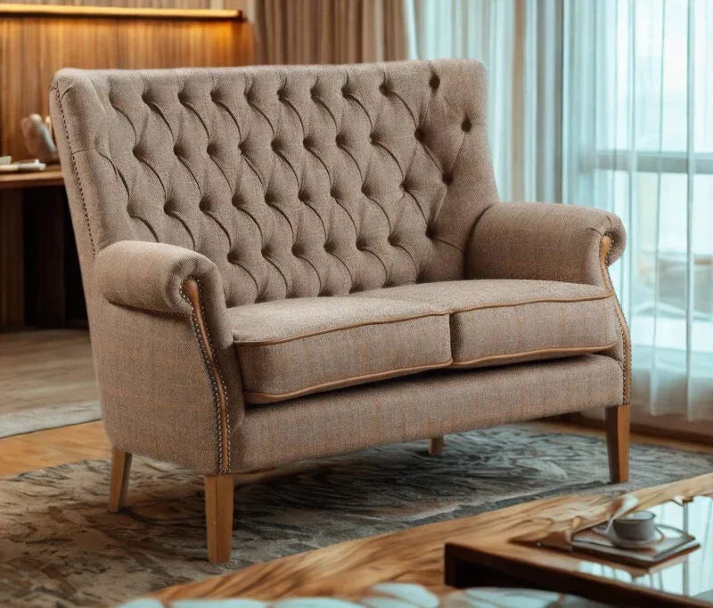 Beige fabric two-seater sofa with tufted backrest and wooden legs in living room setting