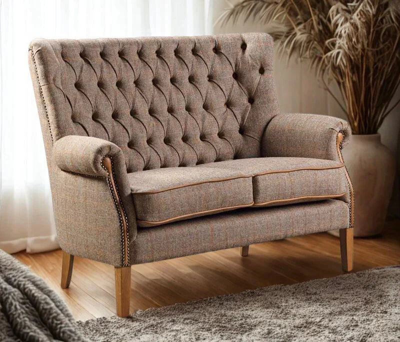 Brown tweed upholstered sofa with button tufted backrest and wooden legs in living room