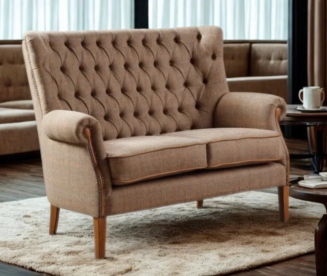 Brown fabric tufted sofa with wooden legs on cream rug in modern living room