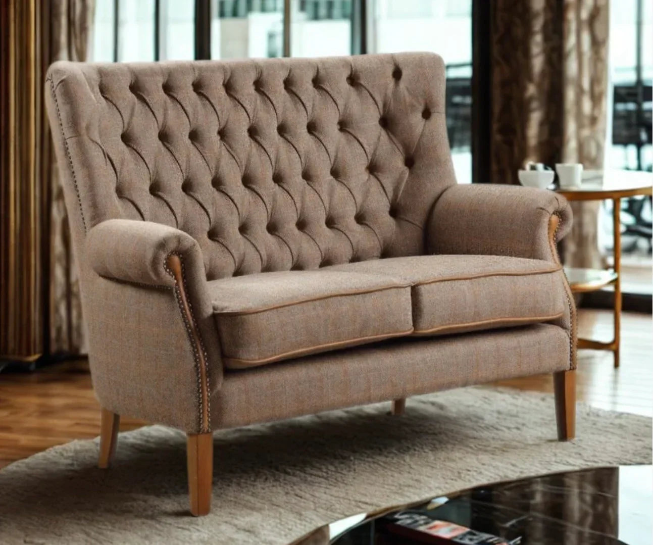 Beige fabric sofa with tufted backrest and wooden legs in contemporary living room