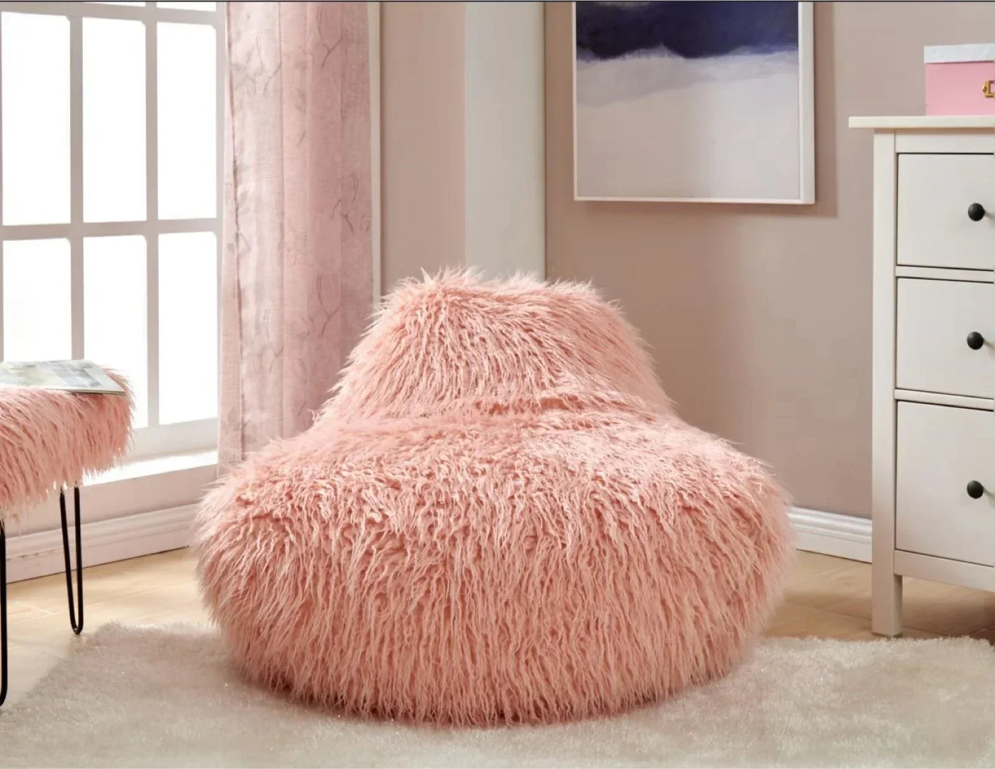 Pink faux fur accent chair on white rug in a modern bedroom