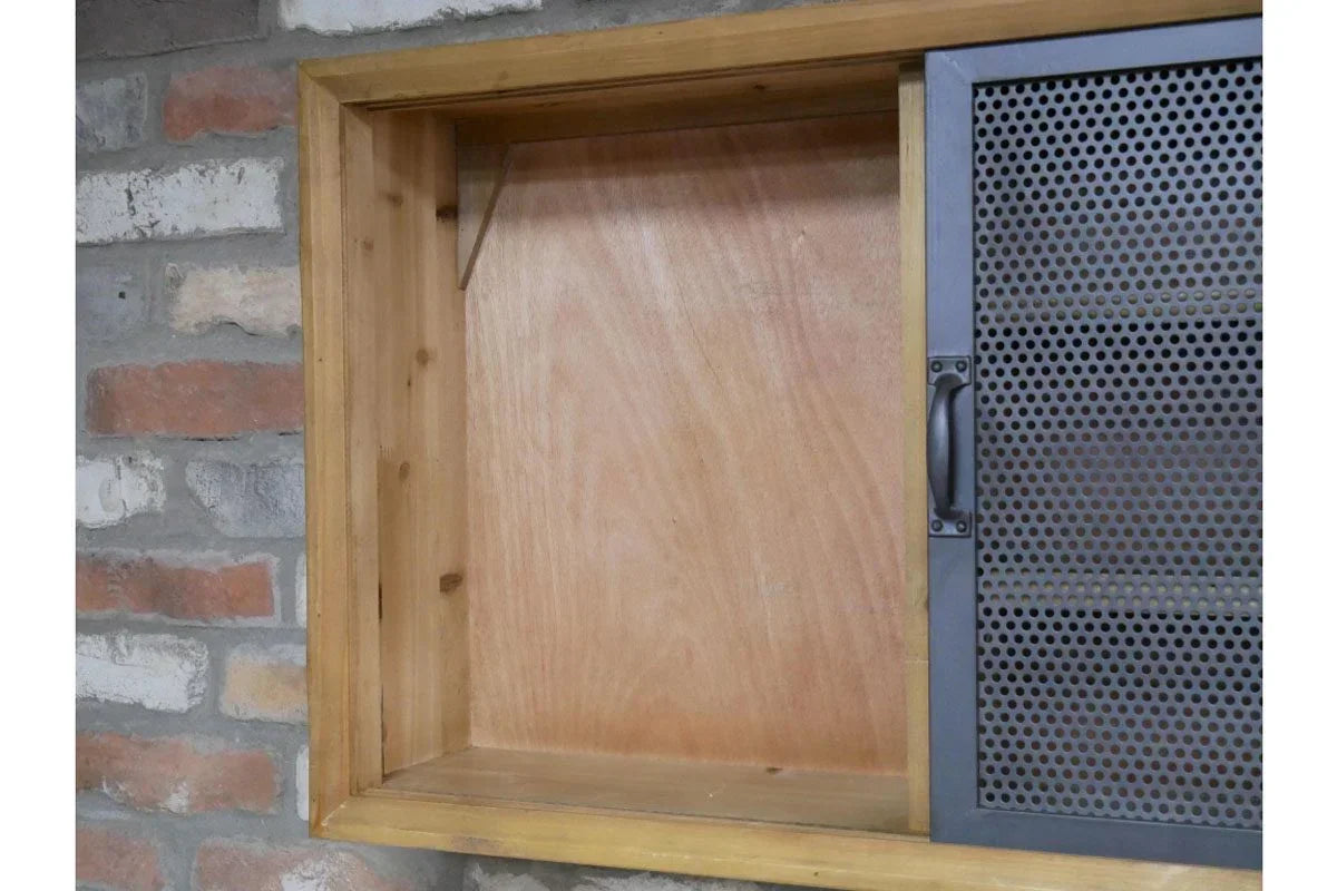 Wood wall cabinet with open storage and grey perforated metal door, brick wall background