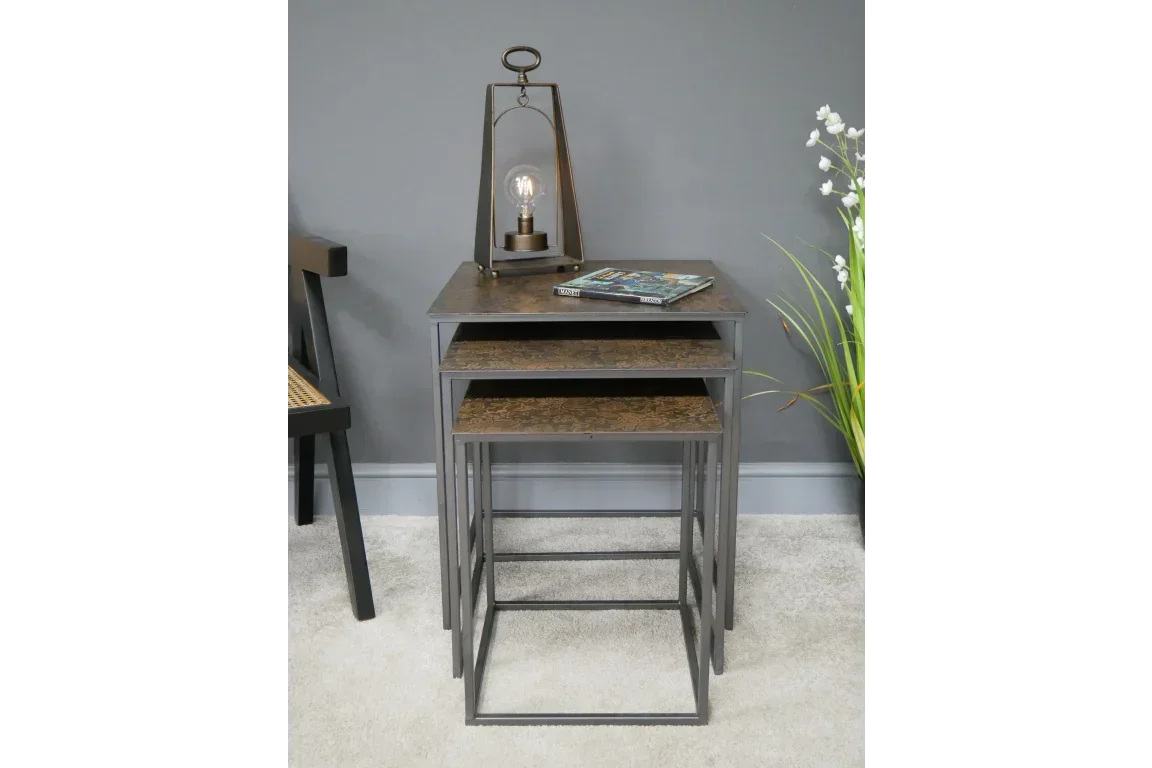 Industrial nesting tables with metal frame and wood tops, lamp and books on top