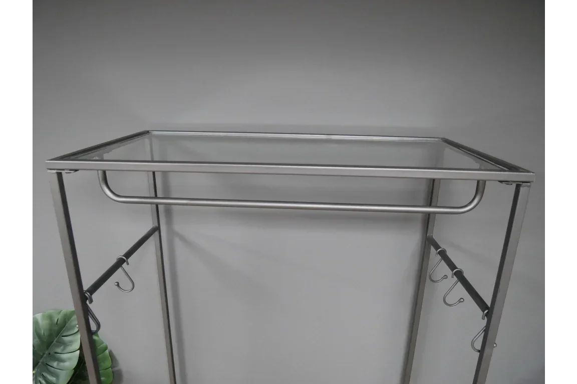 Metal clothes rail with glass shelf and hanging hooks, shown against grey wall