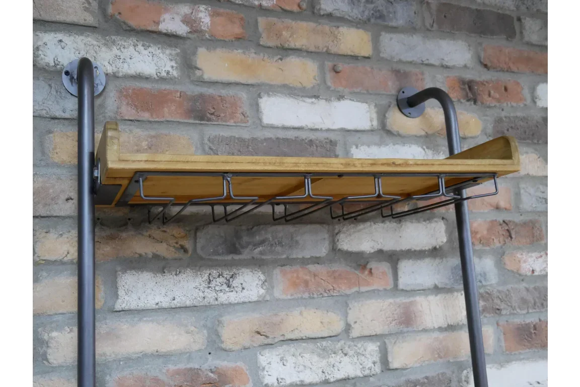 Industrial style wall shelf with metal frame and wooden base mounted on exposed brick wall