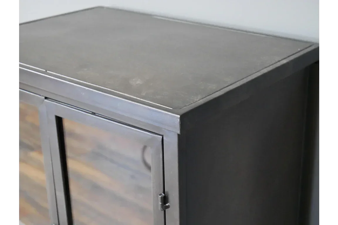 Industrial sideboard with black metal frame and smooth top surface, close-up corner view