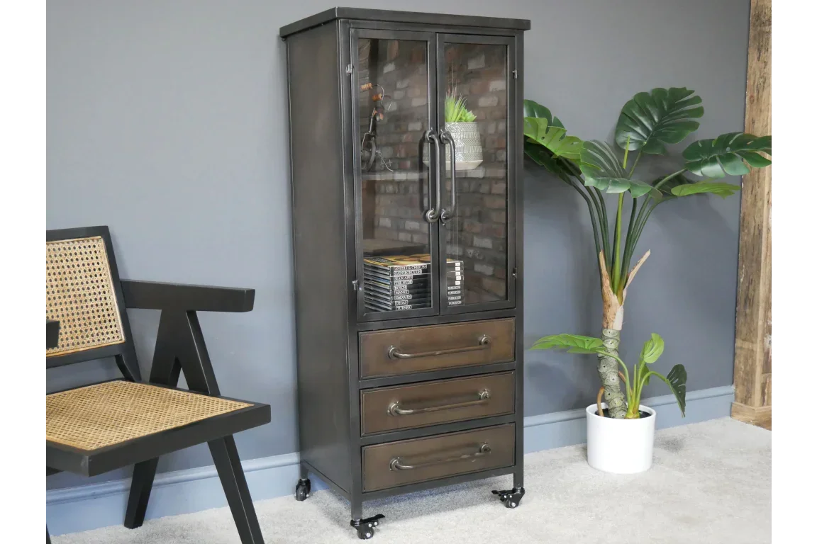 Industrial metal display cabinet with glass doors and three drawers on castor wheels
