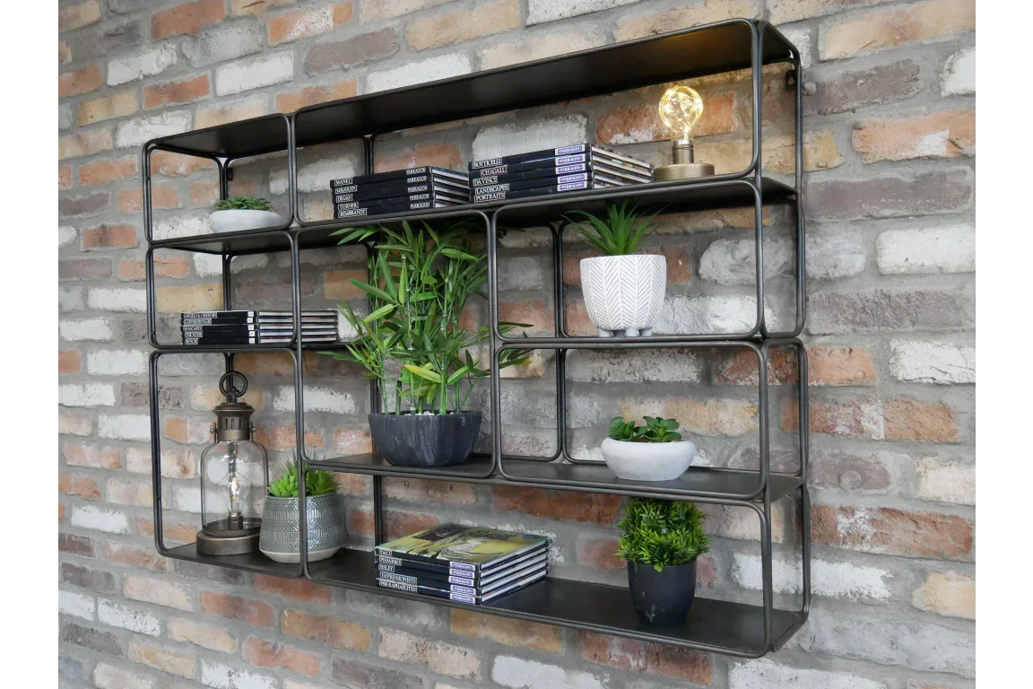 Metal wall shelf with books, potted plants, and decorative lamp on exposed brick wall
