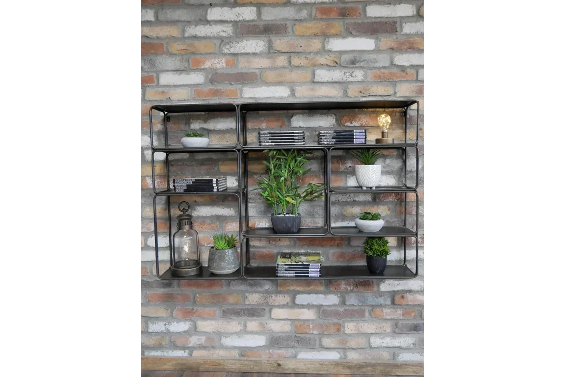 Metal wall shelf with potted plants, books, and decor against exposed brick wall