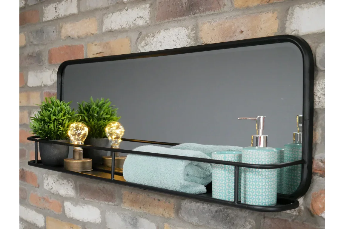 Wall mounted black metal bathroom shelf with mirror, plants, towels and soap dispenser