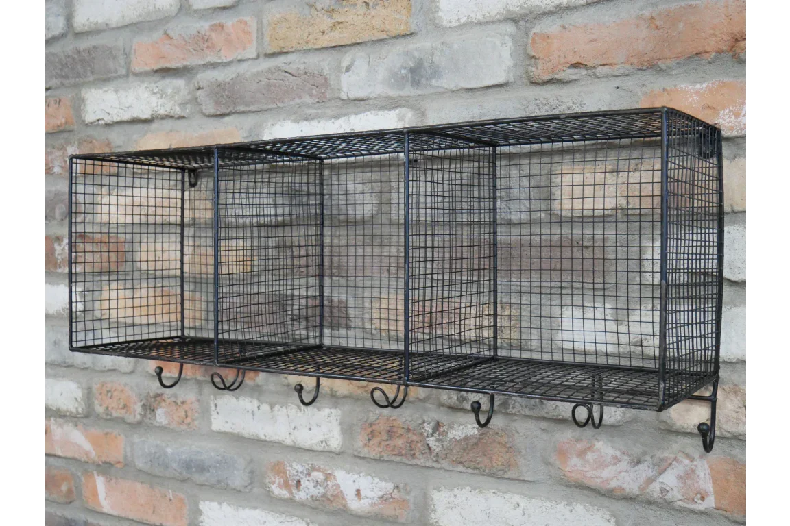 Black metal wire wall storage shelf with hooks mounted on brick wall