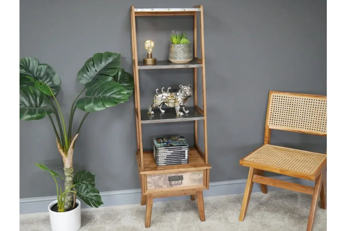 wooden shelving unit with storage drawer beside rattan chair and potted plant