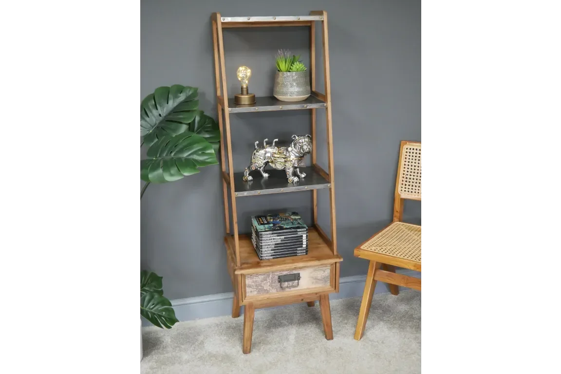 Wooden ladder shelf with drawers, decorated with books, ornaments and a potted plant