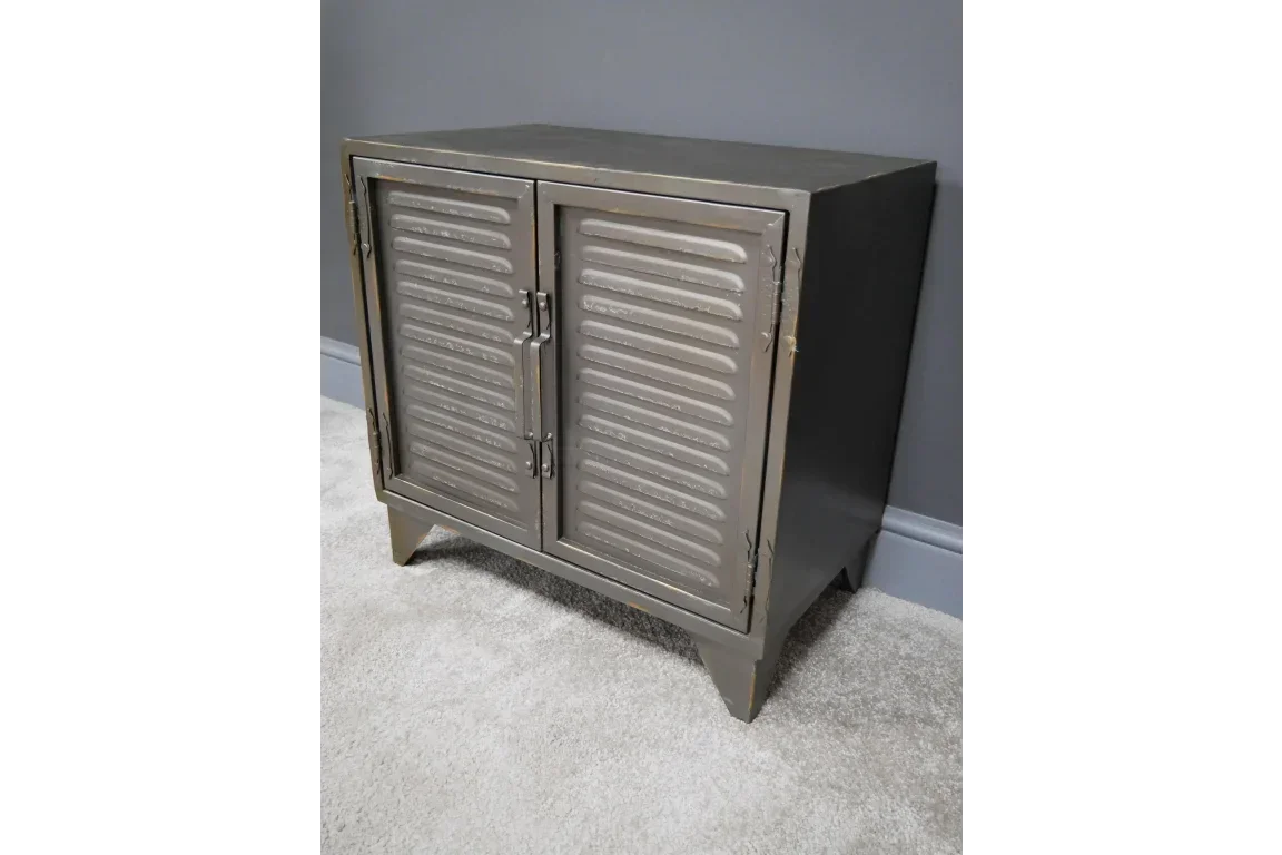 Industrial metal cabinet with two louvered doors and handles, set against grey wall