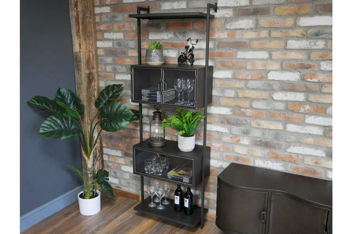 Industrial black metal shelving unit with glass doors holding glasses, plants, and bottles