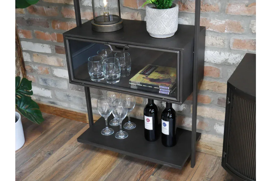 Industrial metal shelving unit with glassware, wine bottles and plant against brick wall