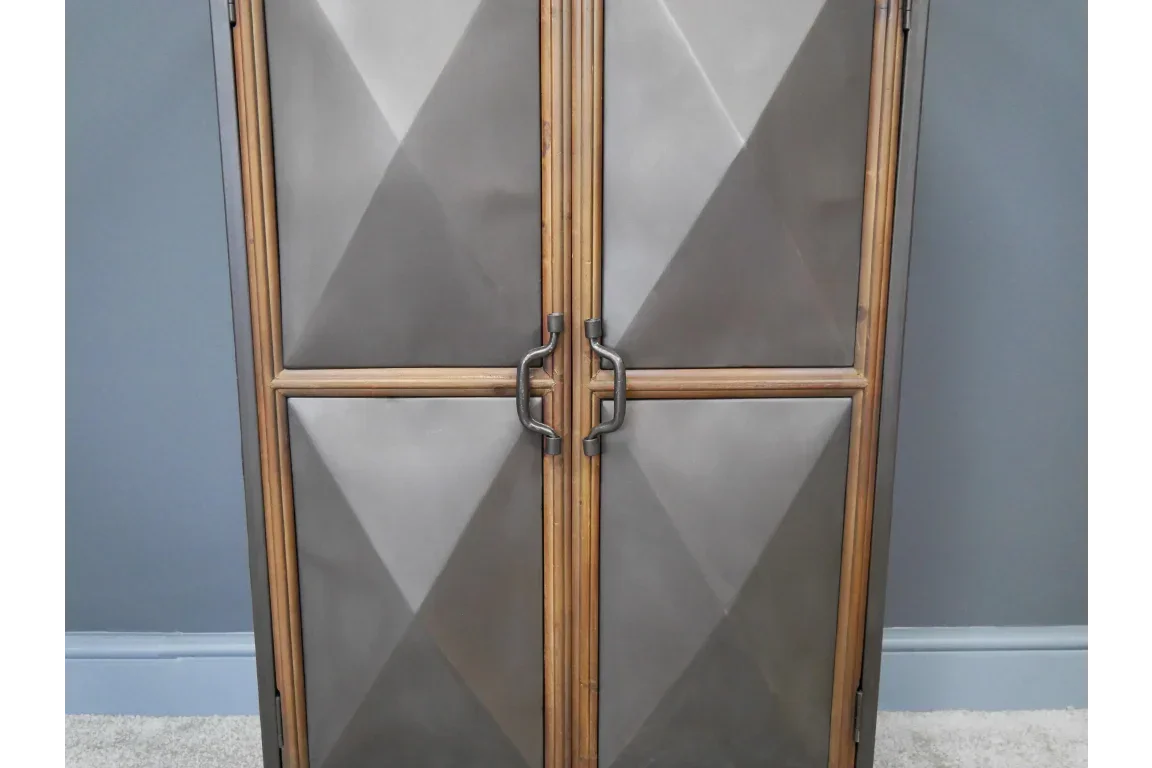 Metal and wood geometric cabinet with double doors and dark handles against grey wall