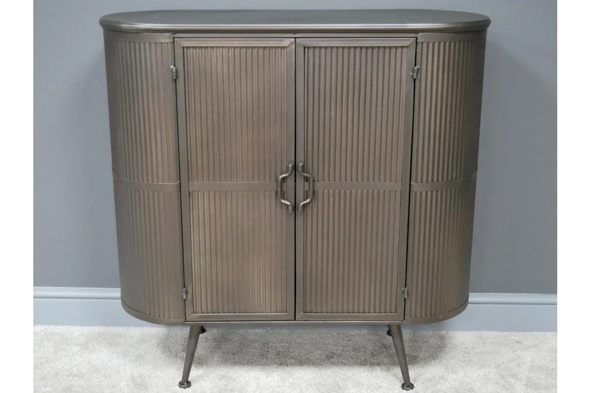 Metal sideboard cabinet with ribbed doors and curved edges on slim legs