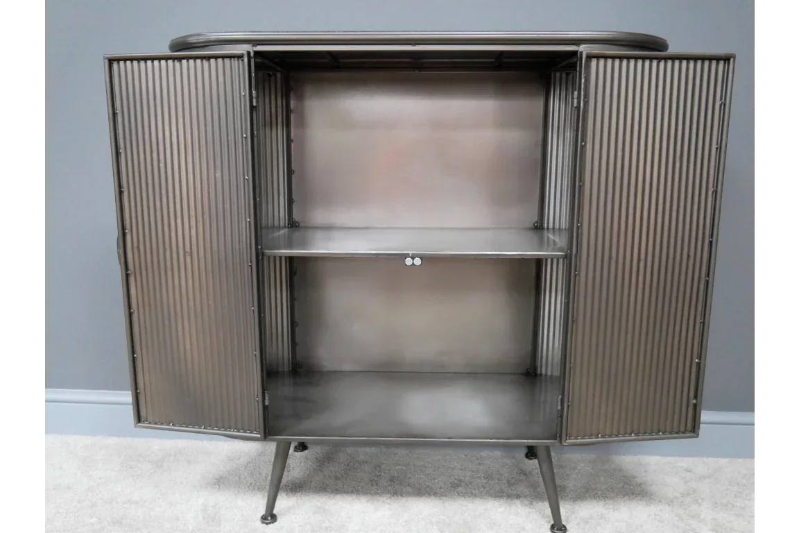 Metal sideboard cabinet with ribbed doors open, two shelves, and angled legs on carpeted floor