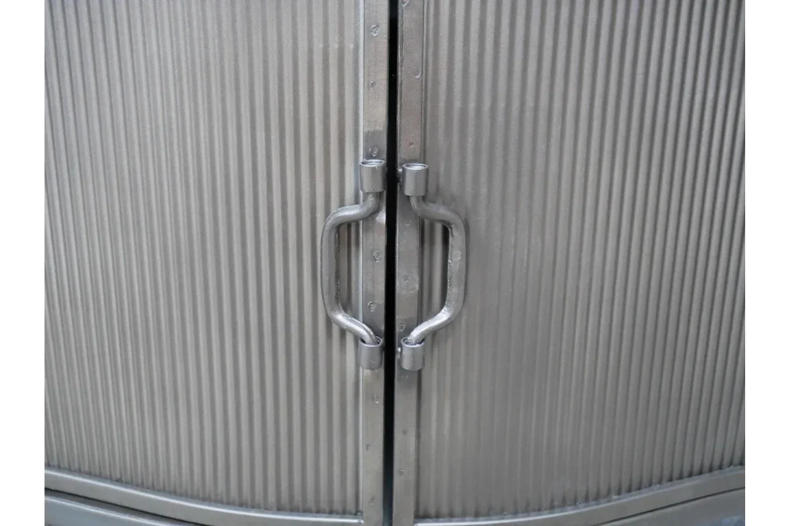 Close-up of metal cabinet with ribbed doors and silver handles