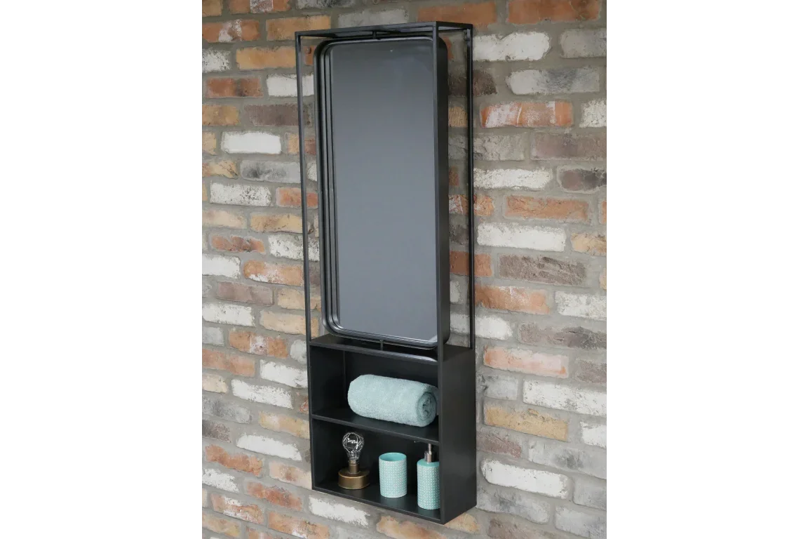 Industrial wall mirror with black metal frame and storage shelves against brick wall
