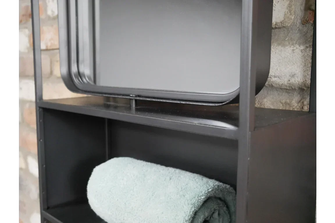 Black metal shelving unit with rolled towel and rectangular mirror against brick wall