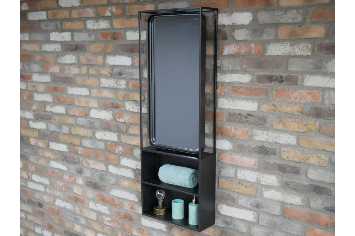 Rectangular wall mirror with black metal frame and storage shelves against brick wall