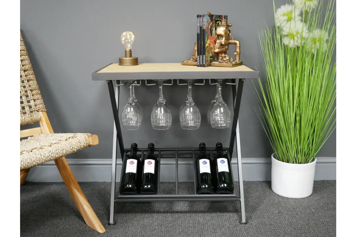 Metal and wood wine rack table with hanging glass holder, wine bottles, and books on top