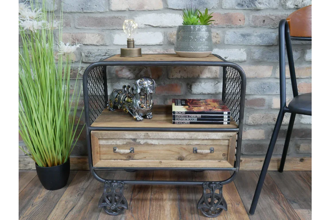 Industrial wood and metal side table with drawer, shelf, books, and decor in a living room
