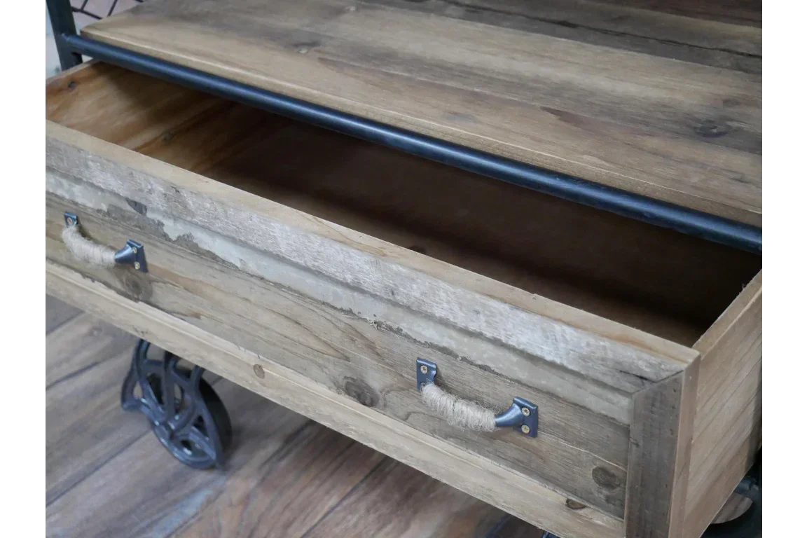 Rustic wooden coffee table with open storage drawer and metal caster wheels on wood floor