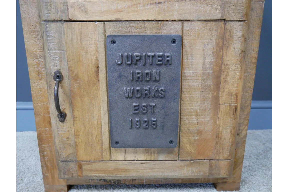 Industrial style wooden cabinet with metal handle and iron plaque detail on door