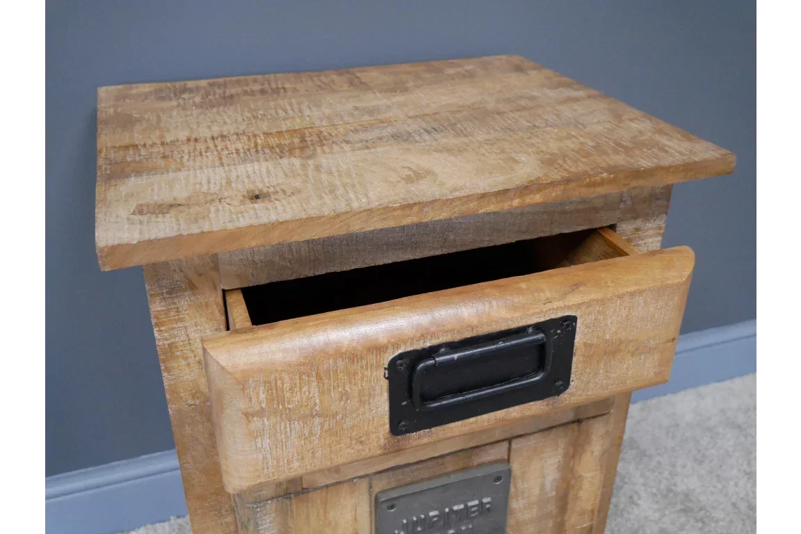 Wooden bedside table with open drawer and metal handle against grey wall