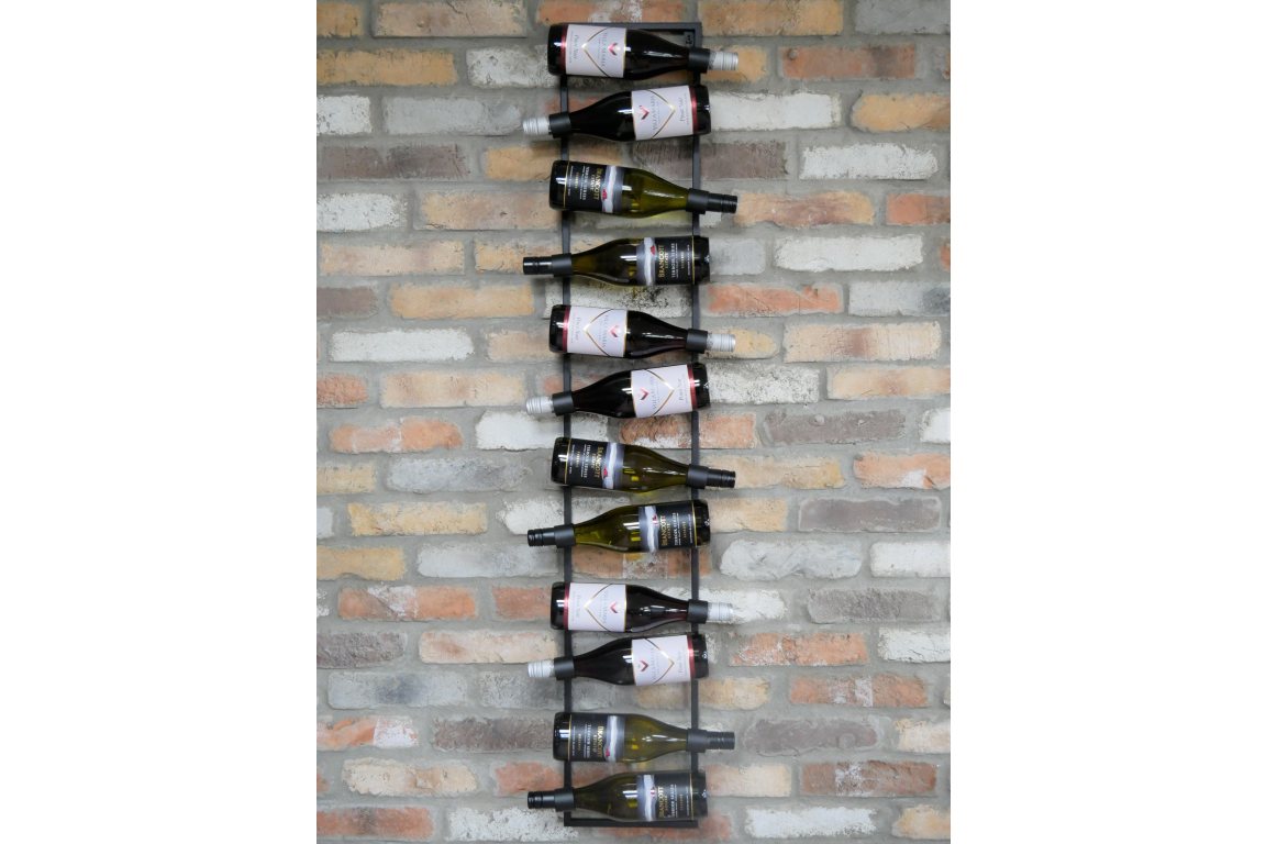 Vertical black metal wine bottle holder mounted on a multicolored brick wall with ten bottles displayed horizontally.