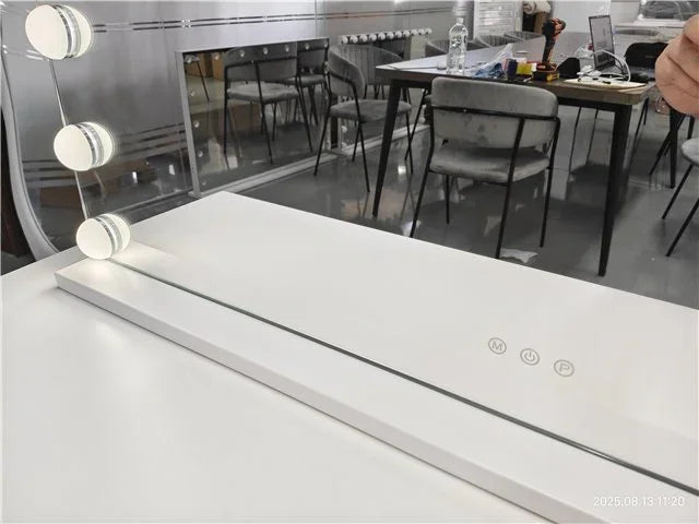 White dressing table with LED mirror lights and touch controls in modern showroom setting