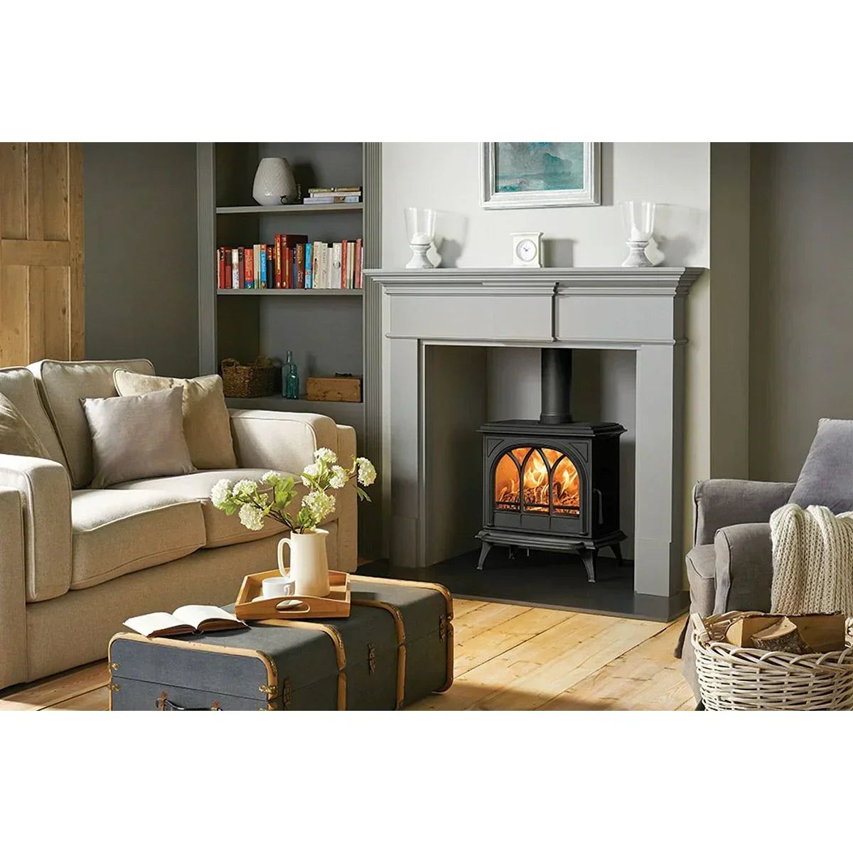Electric stove heater with glowing fire in a modern living room with grey mantel