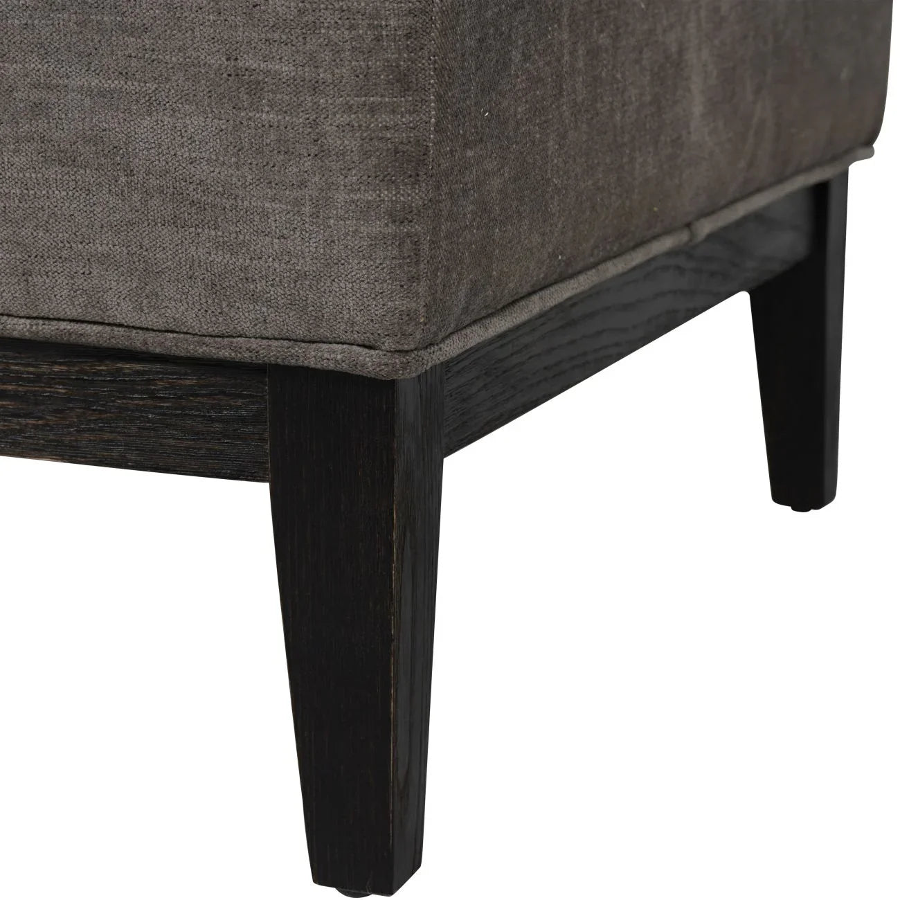 Warm grey fabric stool corner with dark wooden legs.