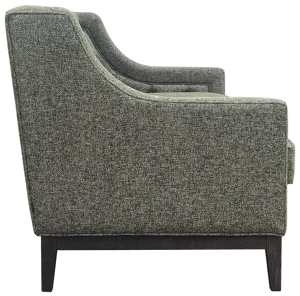 Forest green sofa side view with textured fabric and dark wooden legs.